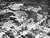 Campus View, 1954:  Aerial photograph from the 1954 Pine Tree showing the campus with its newest additions that were made over the period 1941-1951, including the library (1941), barracks and trailers to house veterans and their families (1946), two quonset hut classroom buildings (1947), the music building (1947), the Home Management building (1948), and the new Science Hall (1951).  Grading is shown underway for the new athletic field (Callaghan Stadium), which was completed in 1956.