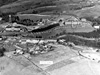 Campus View, 1940:  This first aerial panorama ever made of the campus showed the growth of the campus from the oldest building (Old Main) through 1940.  Campus projects completed during the decade of the 1930s included the addition of a left wing of the gymnasium building (1930), an upgrading of the existing athletic field (1932), and the construction of the Natatorium (1936), Sarvay Hall (1937), and White Hall (1939).  Note the construction of the new library is underway in 1940.  In the foreground on Faculty Hill, new residential housing for members of the college's administration and faculty included the President's House (1932) and five residences for families of faculty members and administrative officers (1936).